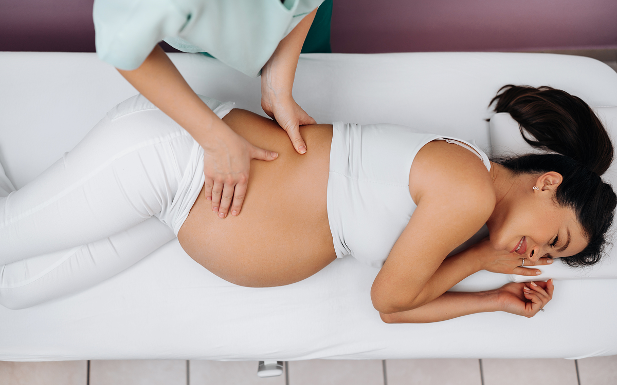 Pregnant woman receiving a relaxing massage.