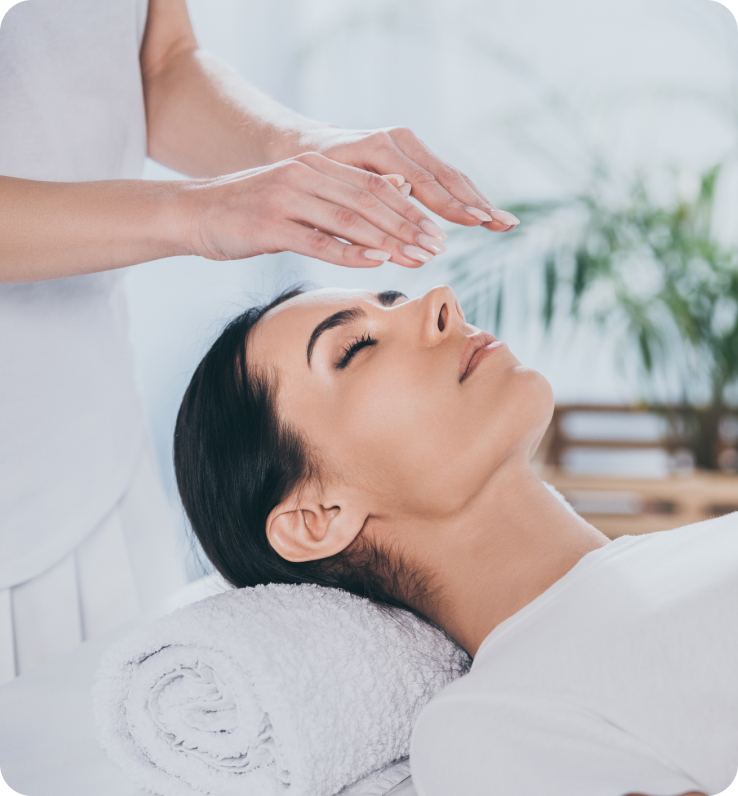 Woman receiving a relaxing reiki session.