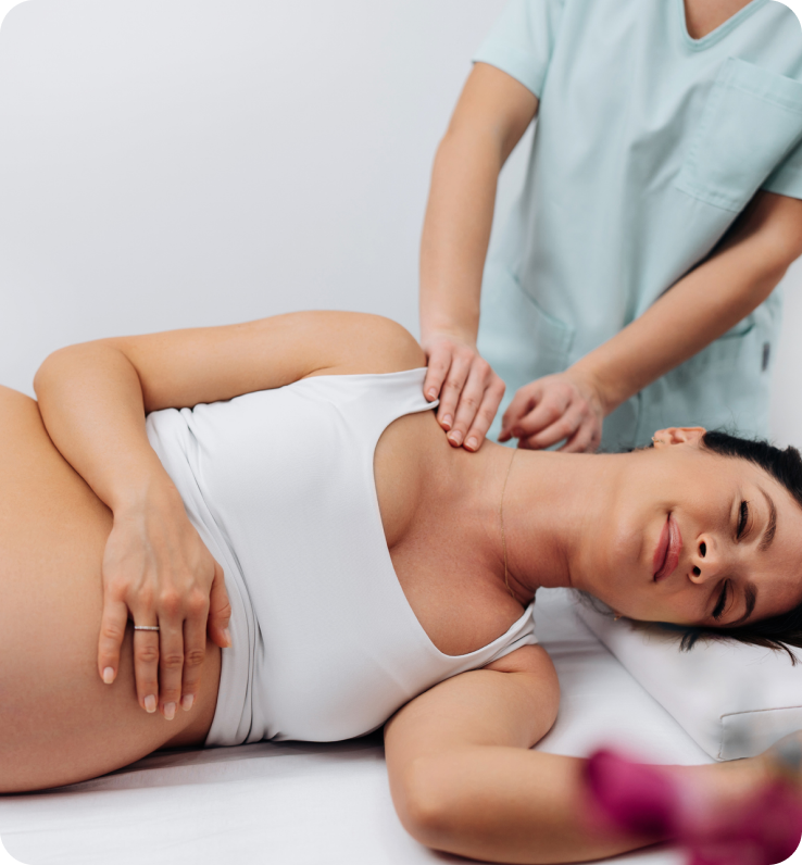 Pregnant woman receiving shoulder massage therapy.