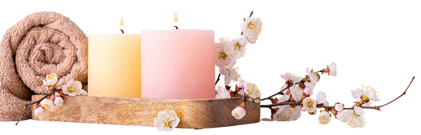 Candles, towel, and flowers on wooden tray.