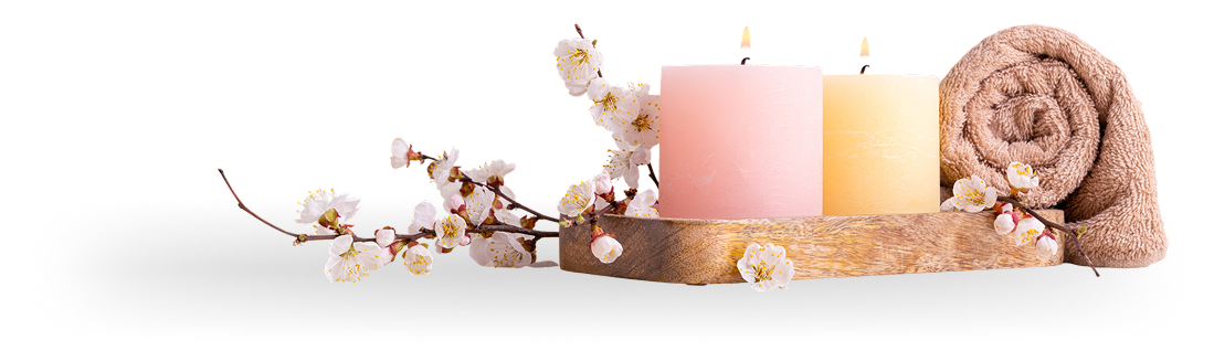 Candles and flowers on wooden tray.